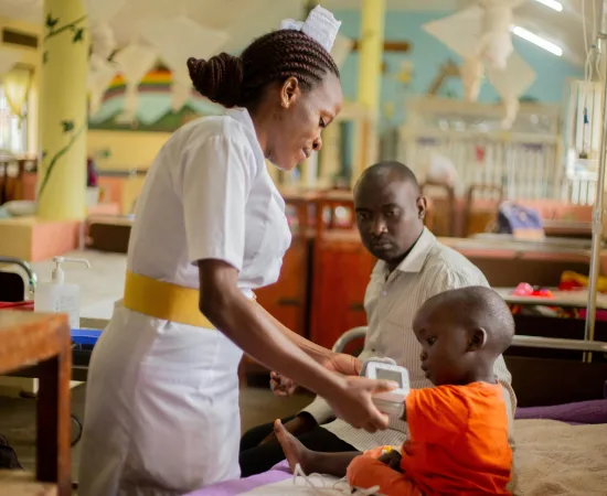A community health worker caring for a child